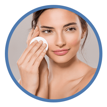 woman wiping face with cotton pad